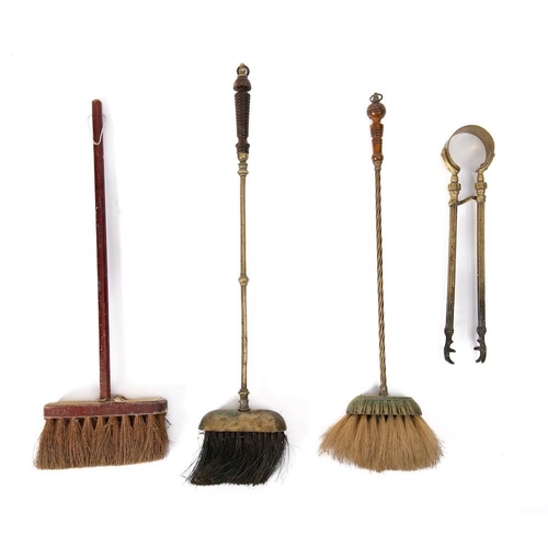 451 - Two brass handled hearth brushes:, a wooden hearth brush, a pair of brass fire tongs, etc.