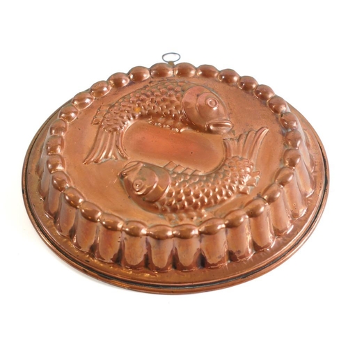 48 - An oval tinned copper pie mould:, decorated with two fish, having reeded border, 34 x 28cm.