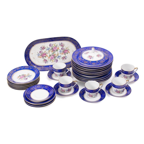 488 - A Continental blue and gilt banded part dinner and tea service: with floral spray decoration.