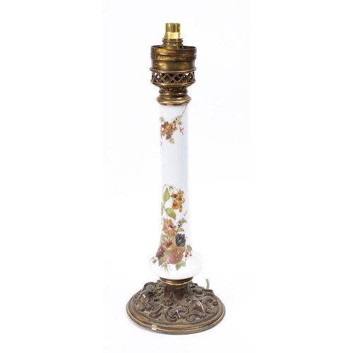 490 - An opaque glass and brass mounted column oil lamp:, the column painted with flowers, on a circular b... 