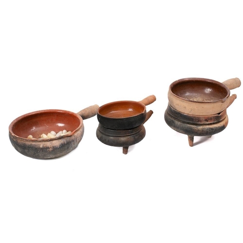 493 - Five graduated terracotta and slip glazed single handled cooking pots: with single lipped bowls.