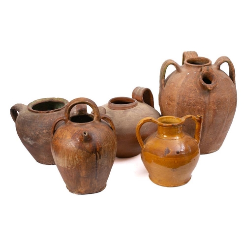 494 - A large French terracotta olive oil jug: of oviform shape with triple handles, 39cm high, another of... 