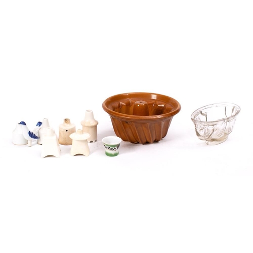 499 - Four pottery jelly or aspic moulds:, two glass examples, one in the shape of a rabbit, together with... 