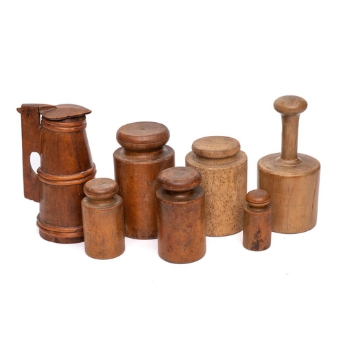 60 - Six various turned wood pie moulds: and a small wood lidded jug of tapering form, 23cm high. (7)