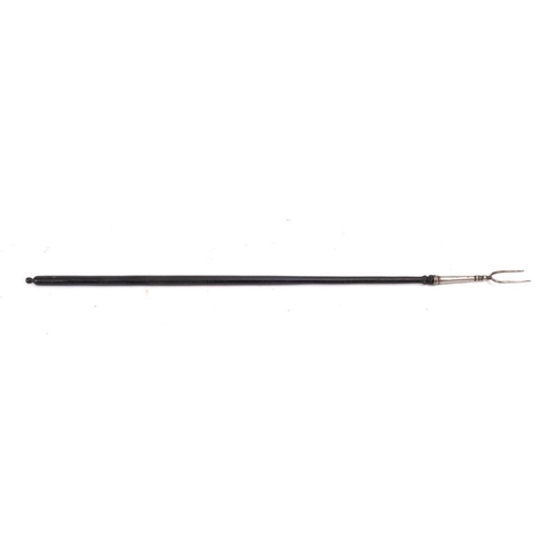 80 - A silver twin pronged toasting fork: with ebonised turned handle, 61.5cm long, London 1894.