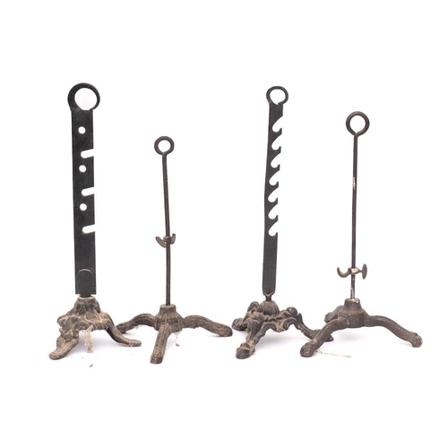 98 - Four various iron spit holders: with ring handles on tripod bases.