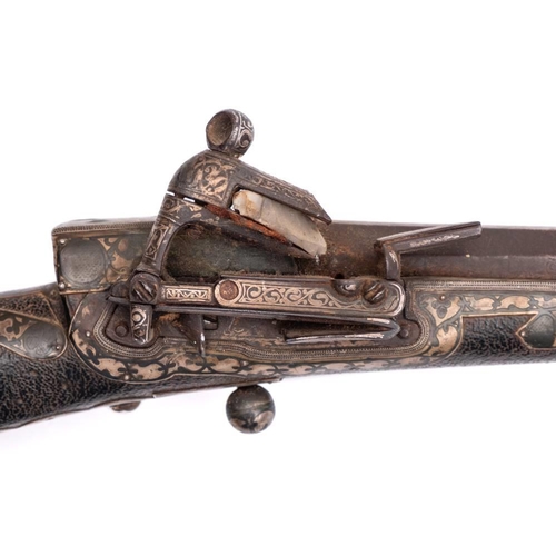 140 - A late 19th century Indo-Persian flintlock musket: the 44 1/2 inch octagonal Damascus barrel with th... 