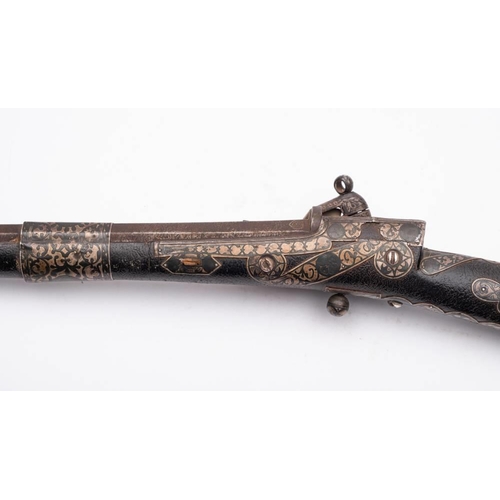 140 - A late 19th century Indo-Persian flintlock musket: the 44 1/2 inch octagonal Damascus barrel with th... 