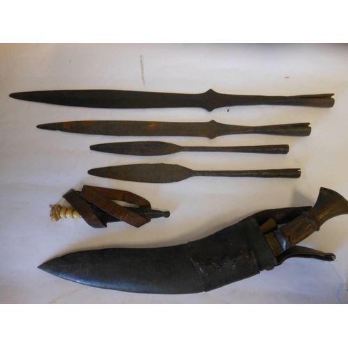 184 - Four Naga Hills spearheads : together with a kukri contained in a leather scabbard and a bone handle... 