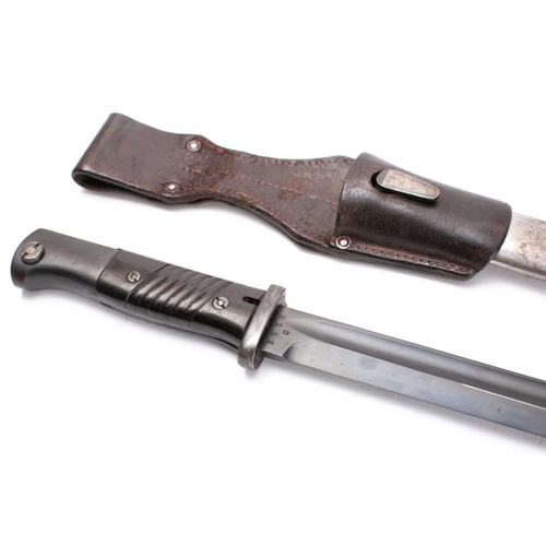 196 - A WWII German S84/98 pattern bayonet, circa 1940: the straight single edge fullered darkened blade s... 