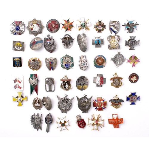 285 - A collection of Polish metal and enamel Regimental association badges: