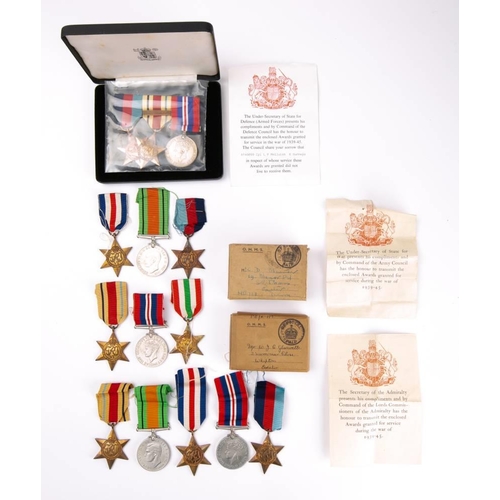 318 - A group of fourteen WWII service medals: two groups in original postage boxes, the third in an assoc... 