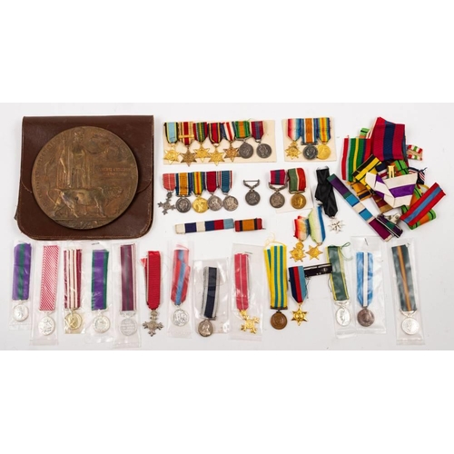 385 - A WWI memorial plaque, together with a quantity of miniature medals.: