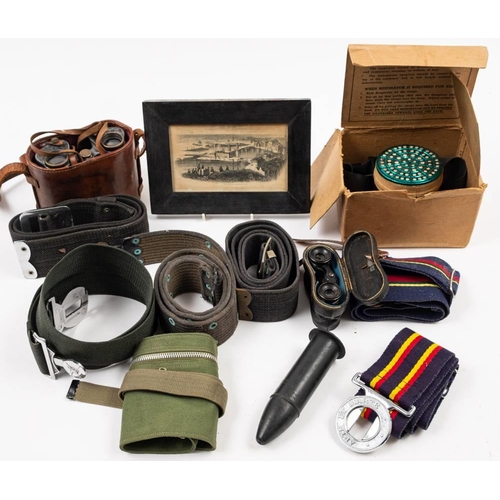 410 - A collection of various militaria: to include a Sam Browne belt, WWII Gas mask, assorted belts, bino... 