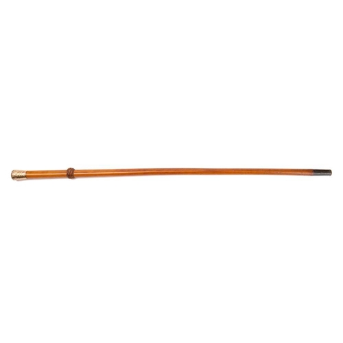 85 - An early 20th century 9ct gold mounted walking cane, London 1914,: the Malacca shaft with leather fe... 