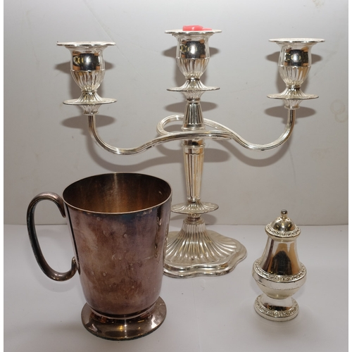 29 - Four assorted silver plated mugs, a twin branch candelabra, butter dish: etc.