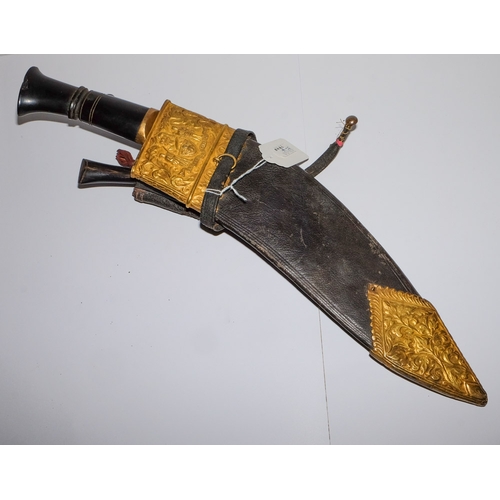 165 - A Malayan Kukri: with 34cm single edged blade, horn grip, with two smaller knives contained in a lea... 