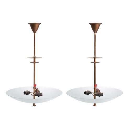 423 - A pair of circular glass dish ceiling lights: on slender and flat knopped stems, 48cm diameter.