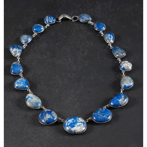 65 - A graduated lapis lazuli pebble mounted necklace: with spectacle frame settings, length ca. 43cm, we... 