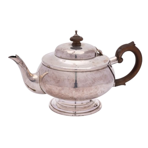 129 - A George V silver bachelor's teapot, maker's mark worn, London, 1931: of plain circular form, with d... 