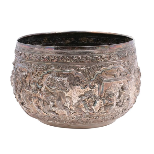 211 - A large Burmese silver bowl: with embossed decoration of ox drawn carts, elephants, palace scenes wi... 