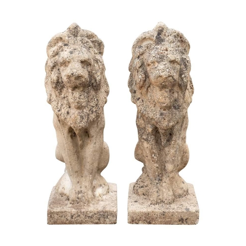 2349 - A pair of stone composition pier finials cast as sejant lions, 20th century,:  56cm high