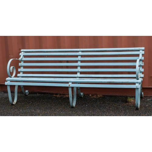 2360 - A wrought iron and slatted wood garden bench, early 20th century,: the scrolling arms descending int... 