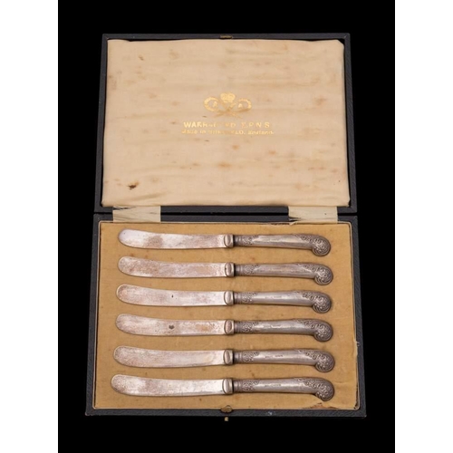 94 - A set of six silver pistol handled butter knives: cased and a cased set of silver mounted manicure i... 