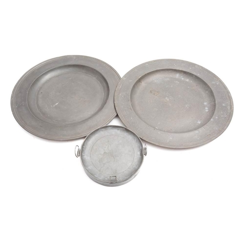 134 - Two pewter chargers: 42.5cm diameter and a pewter warming plate (3)