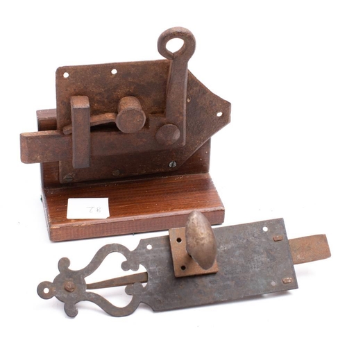 239 - A large iron spring loaded door latch, 18th/19th century. mounted on a later wooden stand, 21cm high... 