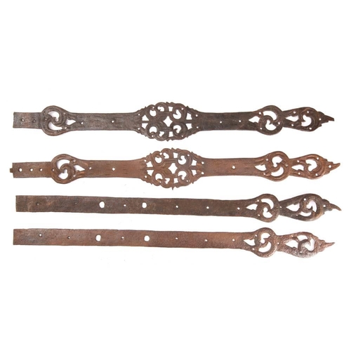 249 - Two pairs of steel straps, possibly 16th century: with pierced scrollwork decoration, 71cm -74cm lon... 