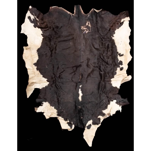 392 - A large black and white cow skin: 226 x 170cm.