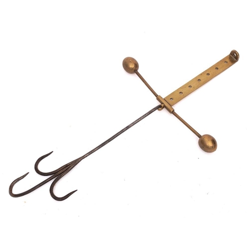 41 - A brass and iron adjustable meat hook: having triple iron spikes on an adjustable brass bar with bal... 