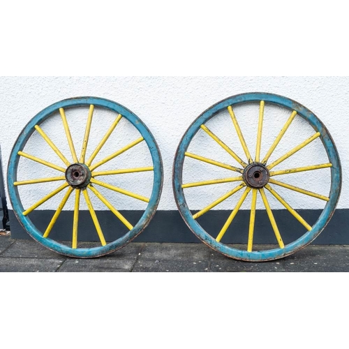 668 - A pair of  cartwheels: of fifteen spoke pattern with steel banded rims, 140 diameter.