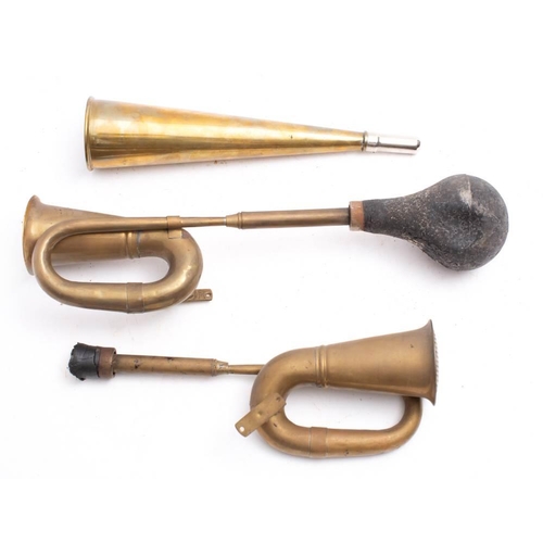 670 - Two reproduction brass car horns and one other  horn: (3)