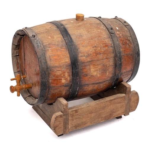 69 - A coopered barrel: with tap, on a wood stand, 32cm long.