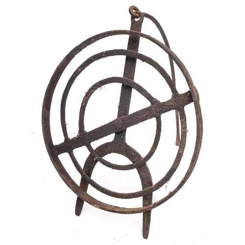 77 - A circular wrought iron revolving grid iron: with scrollwork designs and tripod feet, 31cm diameter,... 