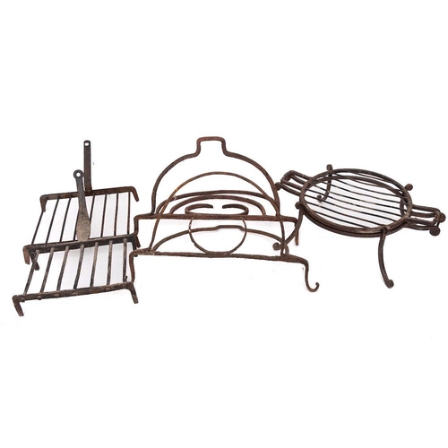 79 - A wrought iron square grid iron:, another rectangular, a circular twin-handled grid iron and stand w... 