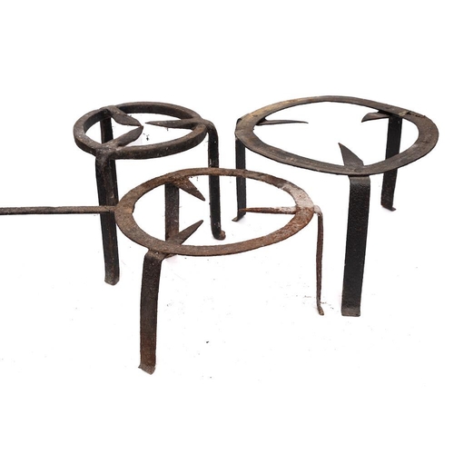 90 - Three circular iron brandreths:, one with a handle, each on tripod feet, 42cm, 36cm and 28cm diamete... 