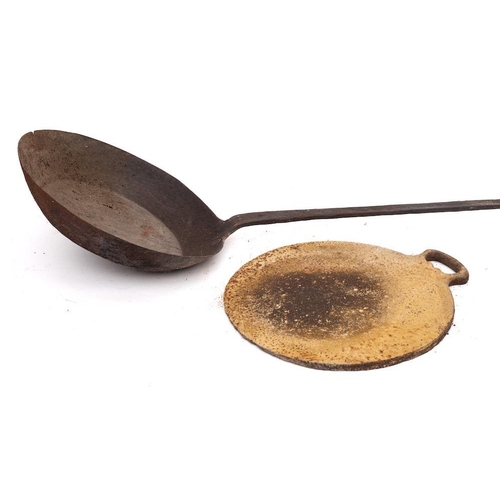 92 - An iron long handled frying pan:, 144cm long, together with a circular iron griddle pan with handle ... 