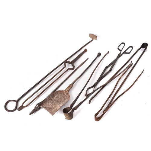 97 - A collection of wrought iron fire implements: including tongs, pokers, rake and shovel.