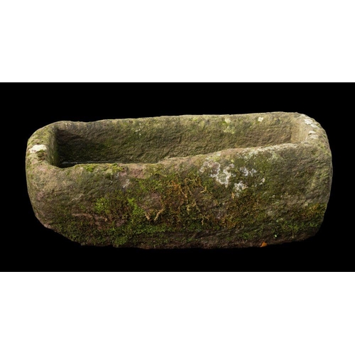 1446 - A rough hewn limestone trough, 18th or 19th century; of loosely rectangular form; 37cm high,104cm lo... 