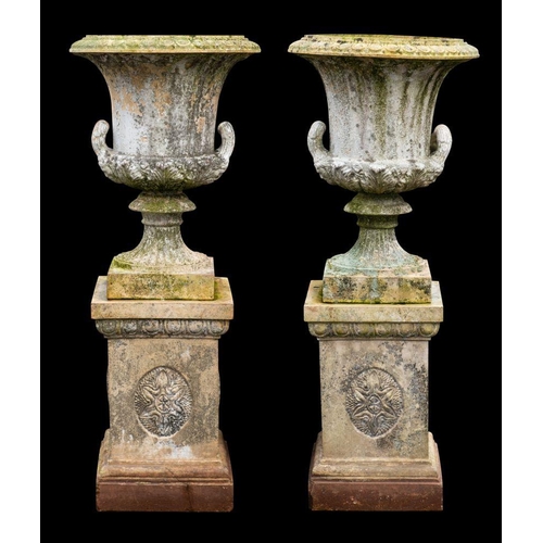 1447 - A pair of Victorian stoneware twin handled garden urns on plinths, late 19th century; each of Campan... 