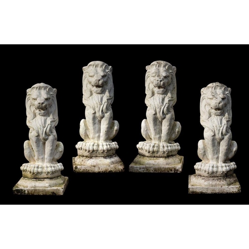 1449 - A set of four white painted reconstituted stone garden models of lions, 20th century; each portrayed... 