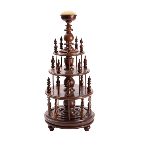 357 - A 19th century rosewood bobbin stand of circular form,  three graduated tiers and with pin cushion f... 