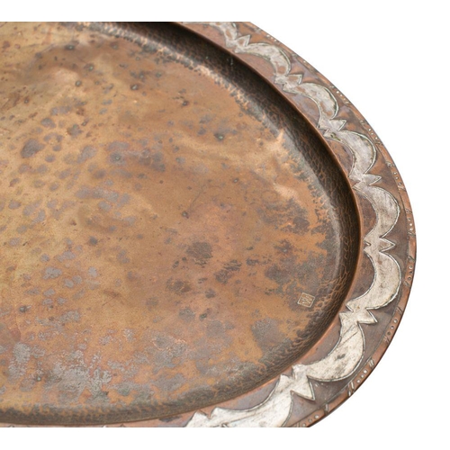 453 - An Arts and Crafts period copper tea tray of oval outline, with silvered scalloped designed border, ... 