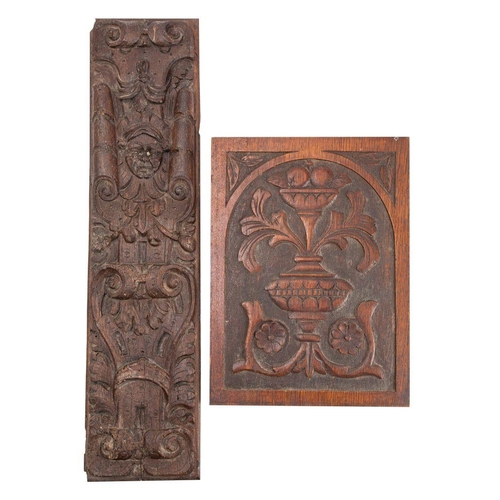 516 - A relief carved oak rectangular panel, 17th century with female mask enclosed by scrolls, 73cm long;... 