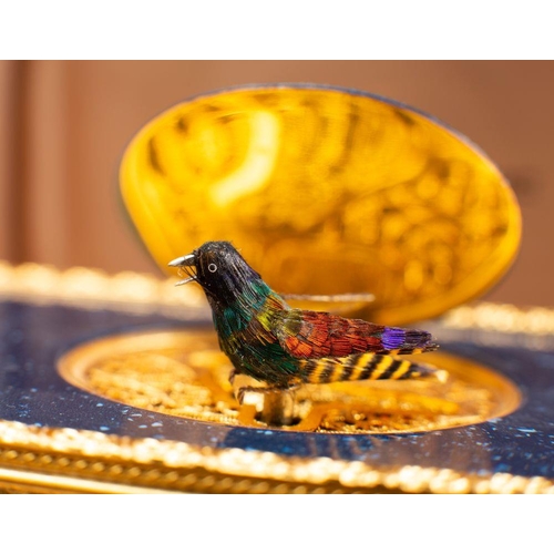 537 - Reuge Music, a Swiss musical box, the flip-up feather covered bird with moving beak and wings,  in a... 