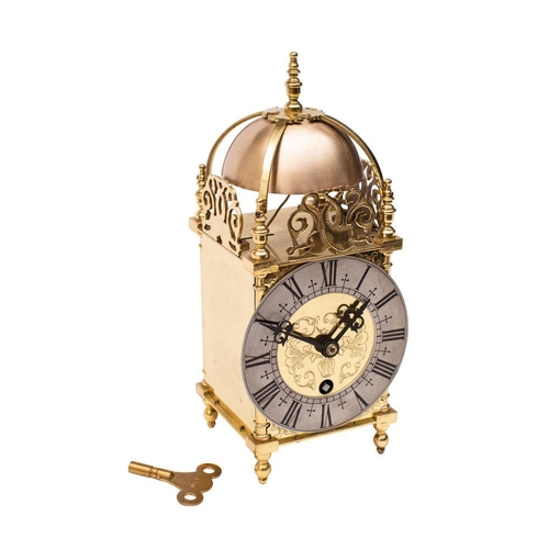 635 - A small reproduction brass lantern clock,  the eight-day duration timepiece movement with passing st... 