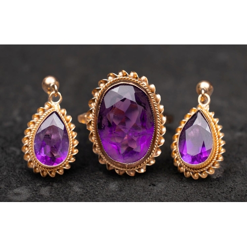 2477 - A 9ct gold, oval, mixed-cut amethyst ring and pair of drop earrings, with ropework surround, the ear... 